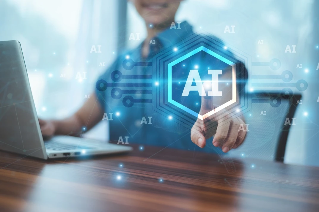 Person using a laptop to interact with an AI interface, displaying various AI elements.