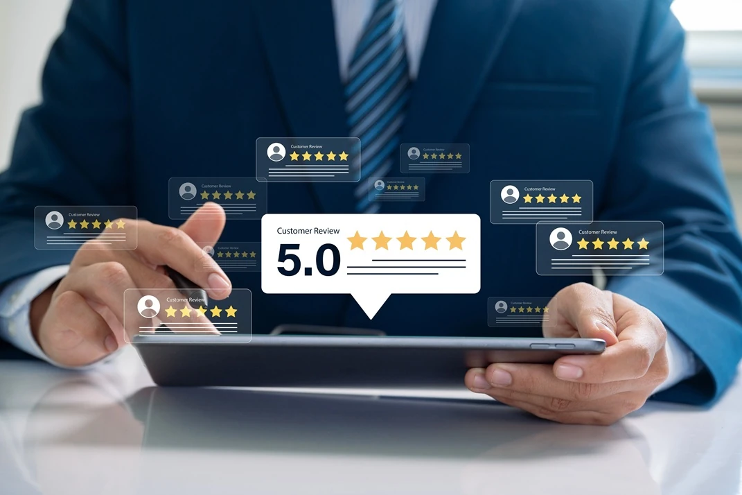 Why Custom AI Models Accelerate Business Growth – Outperforming Generic Alternatives 2 A business professional analyzing customer feedback on a tablet with Lyfe AI, displaying a prominent 5.0-star rating and customer review icons.