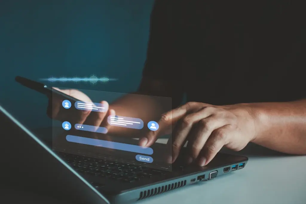 A person using a laptop with messaging features displayed, showcasing how Lyfe AI enhances communication for allied health professionals and their clients.